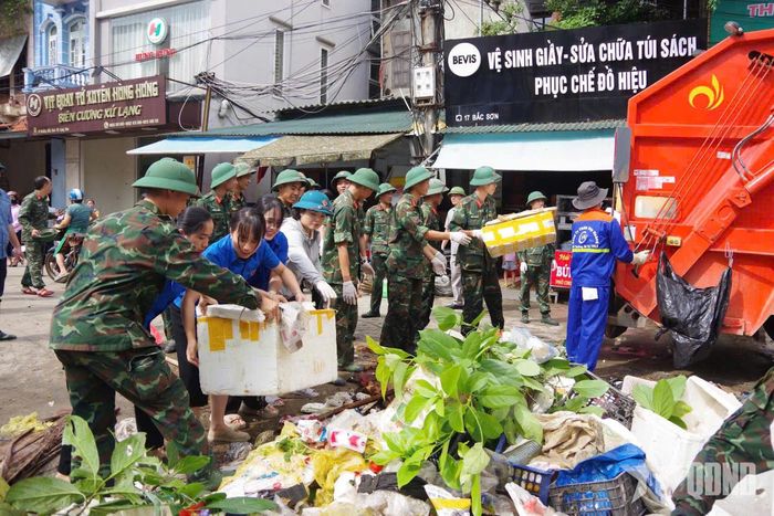 Cán bộ, chiến sĩ Bộ CHQS tỉnh Lạng Sơn, đoàn viên, thanh viên và Sư đoàn 3 (Quân khu 1) phối hợp giúp nhân dân phường Đông Kinh vệ sinh môi trường sau lũ.