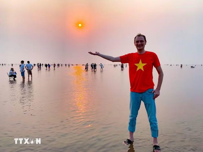 Du khách nước ngoài phấn khích với vẻ đẹp của biển vô cực. (Ảnh: Vũ Quang/TTXVN)