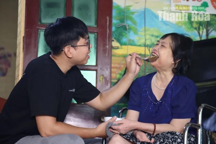 Nguyễn Văn Hùng chăm sóc bà Nguyễn Thị Liên. Sau cơn tai biến hơn hai năm trước, nhiều sinh hoạt hằng ngày của bà vẫn cần người hỗ trợ.