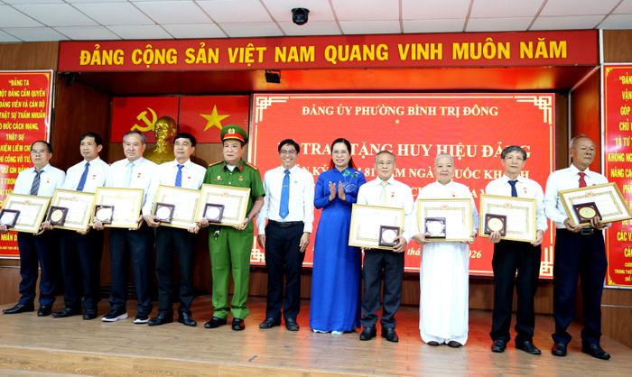  ﻿Phó Bí thư Thường trực Đảng ủy phường Bình Trị Đông Nguyễn Thị Bé Hai (giữa) trao tặng Huy hiệu Đảng đến các đảng viên. Ảnh: LÊ THOA 