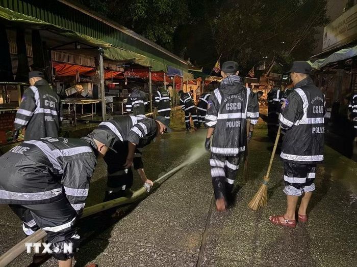 Các chiến sỹ chuẩn bị hệ thống nước để thau rửa toàn bộ chợ. (Ảnh: Tiến Vĩnh/TTXVN)