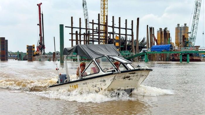 Lực lượng cảnh sát đường thủy (Phòng Cảnh sát giao thông, Công an thành phố Hà Nội) bảo đảm an toàn cho các dự án cầu vượt sông Hồng trong mùa mưa bão. Ảnh: Hùng Mạnh - TTXVN