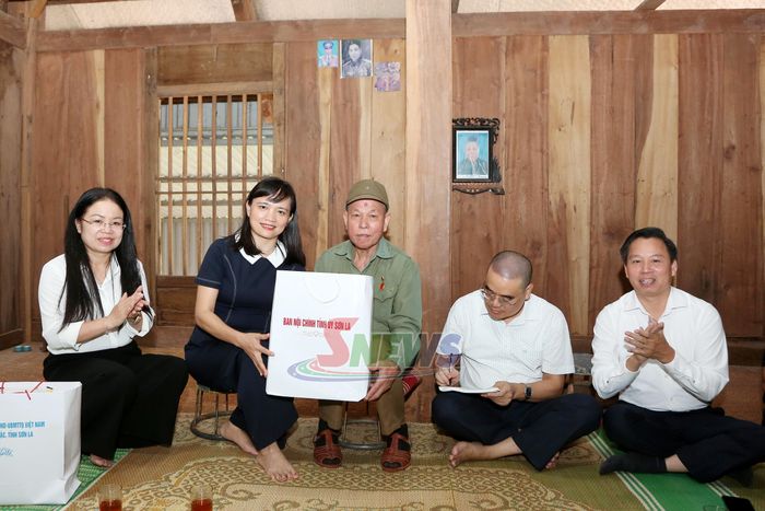 Đồng chí Lường Thị Vân Anh trao quà của Ban Nội chính Tỉnh ủy cho đảng viên Lừ Văn Sé.