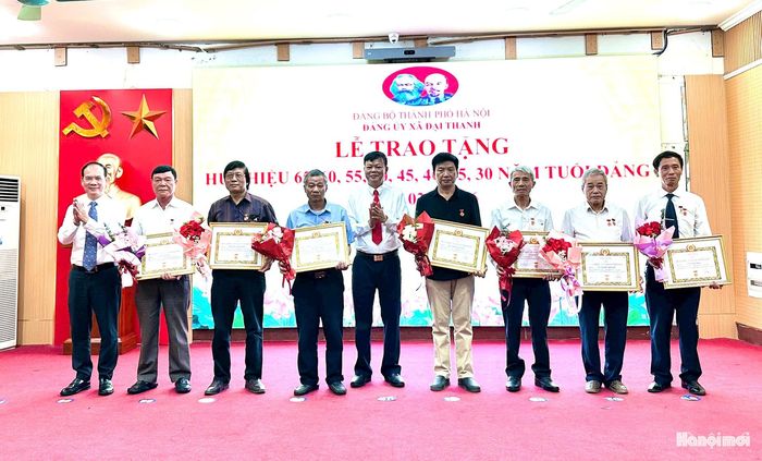 Chủ tịch Ủy ban MTTQ Việt Nam xã Đại Thanh Nguyễn Đình Hiếu trao Huy hiệu Đảng tặng đảng viên. Ảnh: Mai Duyên