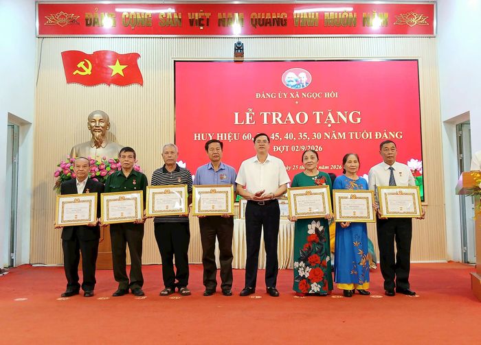 Bí thư Đảng ủy, Chủ tịch HĐND xã Ngọc Hồi Nguyễn Xuân Phong trao Huy hiệu Đảng cho các đảng viên. Ảnh: Hoàng Quyết