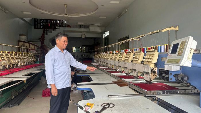 Phó Bí thư Chi bộ thôn Trát Cầu Nguyễn Trọng Vinh giới thiệu với phóng viên dàn máy thêu mặt gối, đệm... của gia đình. Ảnh: PV