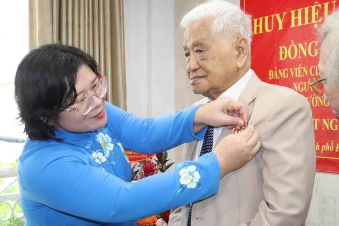  Phó Bí thư Thành ủy TPHCM Văn Thị Bạch Tuyết trao Huy hiệu 80 năm tuổi Đảng đến đồng chí Trần Xuân Nhựt. Ảnh: CẨM TUYẾT 