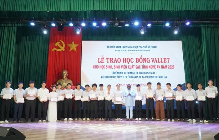 Ông Espéran Padonou, Phó Giám đốc Quỹ học bổng Vallet và ông Thái Văn Thành - Phó Chủ tịch UBND tỉnh Nghệ An trao học bổng cho 33 học sinh Trường THPT chuyên Phan Bội Châu. Ảnh: Hồ Lài