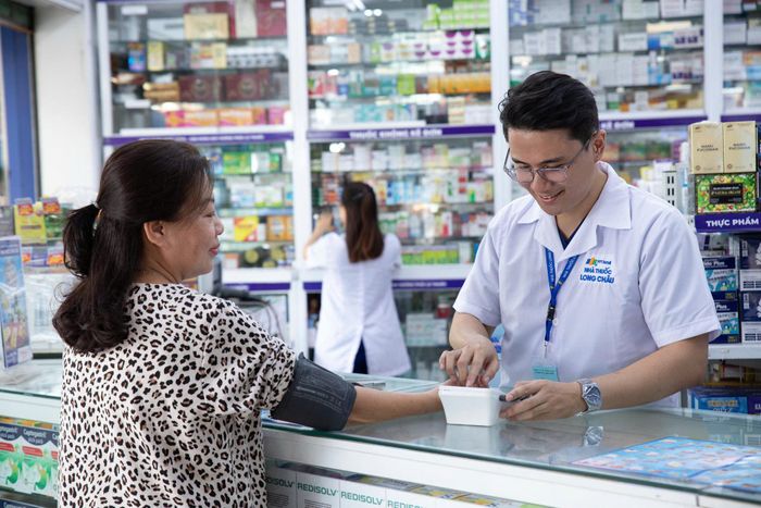 Dược sĩ hỗ trợ người dân kiểm tra huyết áp, phát hiện cảnh báo rung nhĩ ngay tại nhà thuốc.