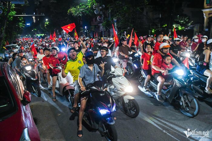 Tại ngã tư Hàng Bài - Trần Hưng Đạo, đám đông dừng đèn đỏ đúng quy định đồng thời “tranh thủ” hò reo mừng chiến thắng.