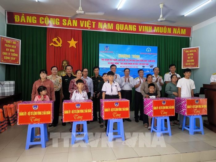 Tặng quà cho 5 cháu là con ngư dân có hoàn cảnh khó khăn, mồ côi được Bộ Tư lệnh Vùng 2 Hải quân nhận đỡ đầu. Ảnh: Huỳnh Phúc Hậu - TTXVN