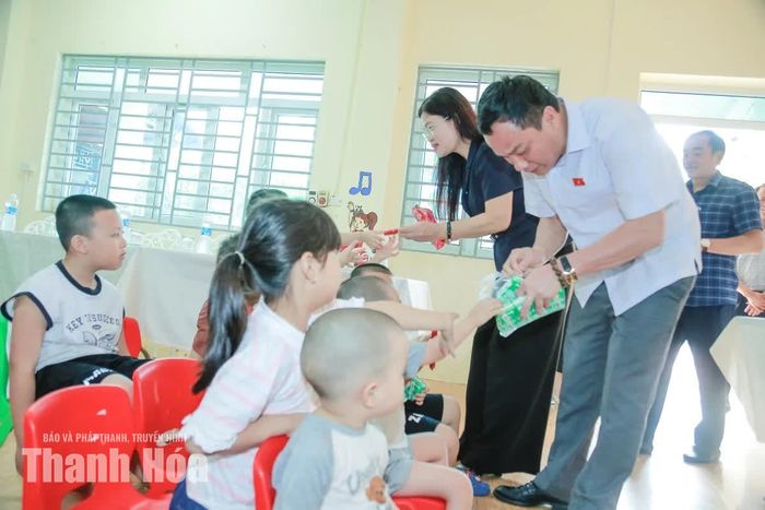 Phó Chủ nhiệm Ủy ban Văn hóa và Xã hội của Quốc hội Triệu Thế Hùng và Phó Trưởng Đoàn ĐBQH tỉnh Thanh Hóa Lương Thị Hoa trao quà cho các em nhỏ đang được nuôi dưỡng tại Trung tâm từ thiện xã hội chùa Hồi Long, xã Hoằng Thanh.