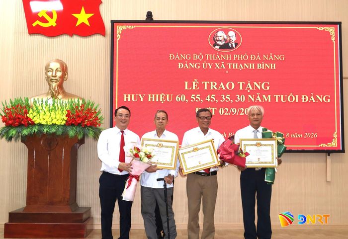 Bí thư Đảng ủy xã Thạnh Bình Trần Ngọc Tài (bìa trái) trao Huy hiệu Đảng đợt 2/9 cho các đảng viên. Ảnh: HƯNG HUYNH