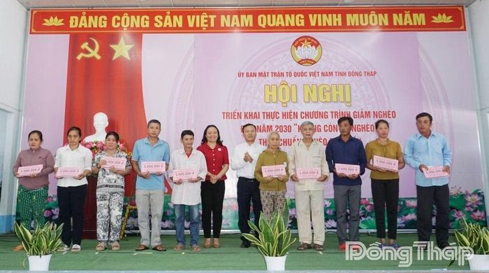 Trao Bảng tượng trưng hỗ trợ vốn sản xuất, sinh kế cho các hộ nghèo tại hội nghị.