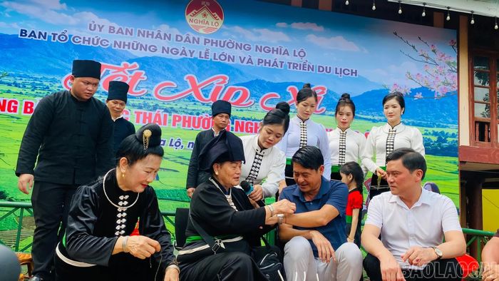Các đại biểu lên sân khấu tham gia nghi thức buộc chỉ cổ tay - gửi trao lời chúc Tết Xíp Xí.