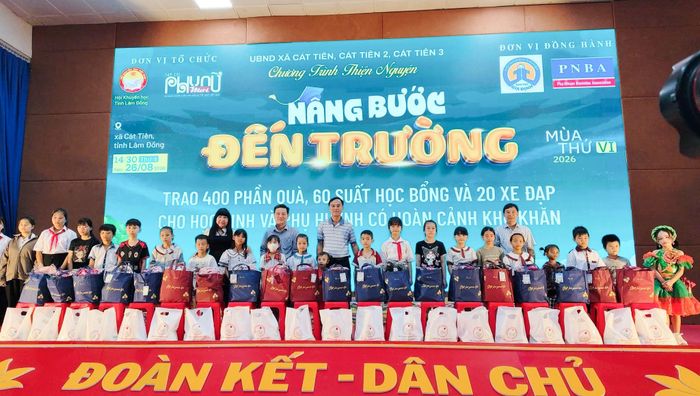 Đại diện lãnh đạo địa phương và các đơn vị tài trợ tặng quà cho các em học sinh, phụ huynh có hoàn cảnh khó khăn trên địa bàn