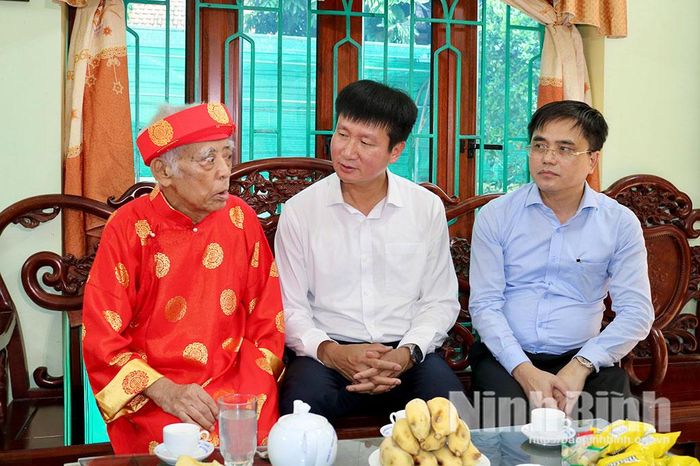Đồng chí Trần Huy Tuấn, Ủy viên Trung ương Đảng, Bí thư Tỉnh ủy động viên, hỏi thăm sức khoẻ cán bộ tiền khởi nghĩa Dương Văn Thung, tổ dân phố Liên Bảo 2 (phường Trường Thi).