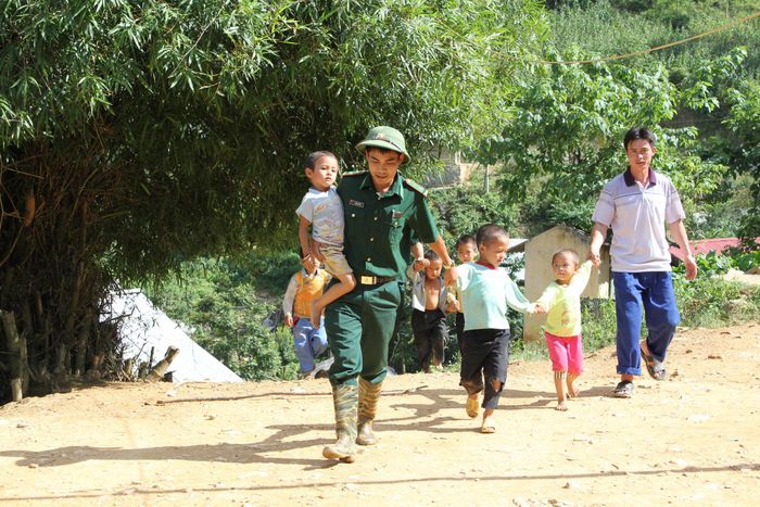 Cán bộ đồn Biên phòng Tả Gia Khâu vận động học sinh đến lớp. Ảnh: Trung Dũng