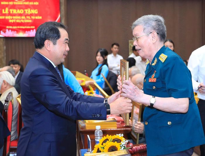 Bí thư Thành ủy Hà Nội Trần Đức Thắng trao Huy hiệu Đảng tặng đảng viên. Ảnh: Nhóm phóng viên