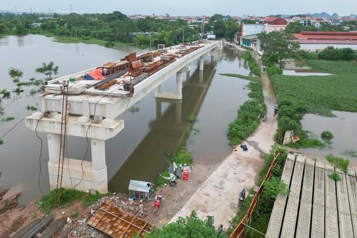 Khu vực cầu Tân Phú bị nước tràn qua. Bên cạnh là dự án cầu Tân Phú mới đang được thi công.