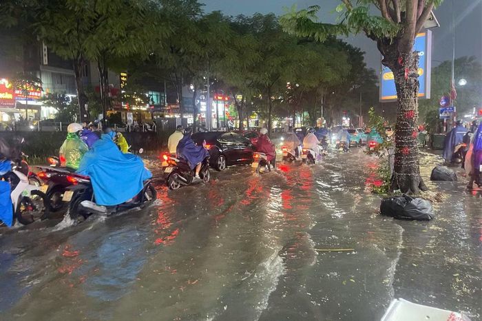Nước dâng nhanh tại nhiều tuyến phố, phủ kín mặt đường và gây khó khăn cho các phương tiện.