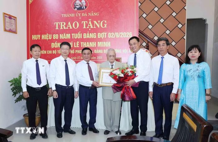 Thường trực Ban Bí thư Trần Cẩm Tú trao Huy hiệu 80 năm tuổi Đảng cho đảng viên lão thành Lê Thanh Minh, phường Hội An, thành phố Đà Nẵng. (Ảnh: Phương Hoa/TTXVN)