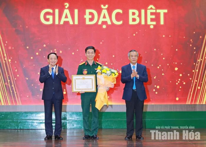 Trưởng Ban Tuyên giáo Trung ương Trịnh Văn Quyết và Bí thư Tỉnh ủy Thanh Hóa Lê Đức Thái trao Giải đặc biệt và tặng hoa chúc mừng cho báo cáo viên Trịnh Xuân Việt, Viện trưởng Viện Khoa học Xã hội và Nhân văn Quân sự thuộc Học viện Chính trị, Bộ Quốc phòng.