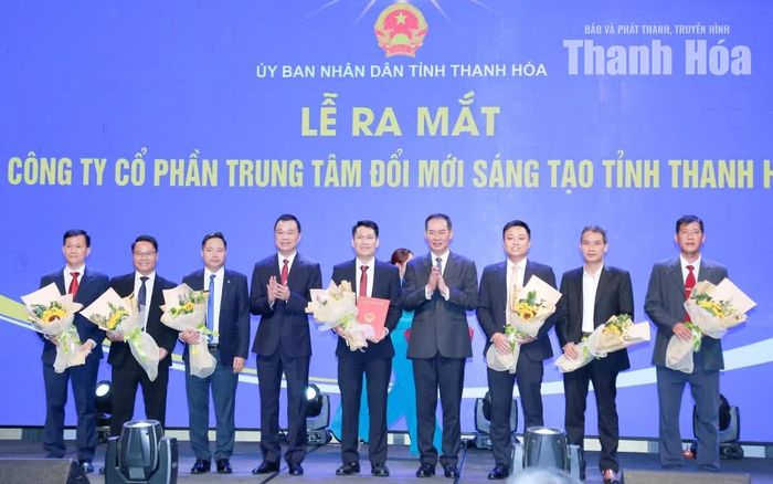 Các đồng chí: Tô Anh Dũng, Phó Bí thư Tỉnh ủy, Chủ tịch UBND tỉnh; Trịnh Tuấn Sinh, Phó Bí thư Tỉnh ủy, Chủ tịch Ủy ban MTTQ tỉnh trao Quyết định và tặng hoa chúc mừng Công ty CP Trung tâm Đổi mới sáng tạo tỉnh Thanh Hóa.