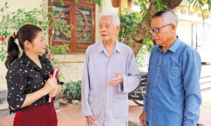 Cụ Hoàng Văn Đến (người đứng giữa) ở thôn Xuân Trung, xã Hợp Thịnh kể về truyền thống cách mạng của quê hương.