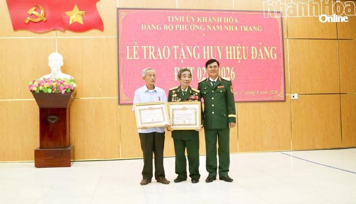 Thiếu tướng Nguyễn Túy trao Huy hiệu 60 năm tuổi Đảng cho các đảng viên.