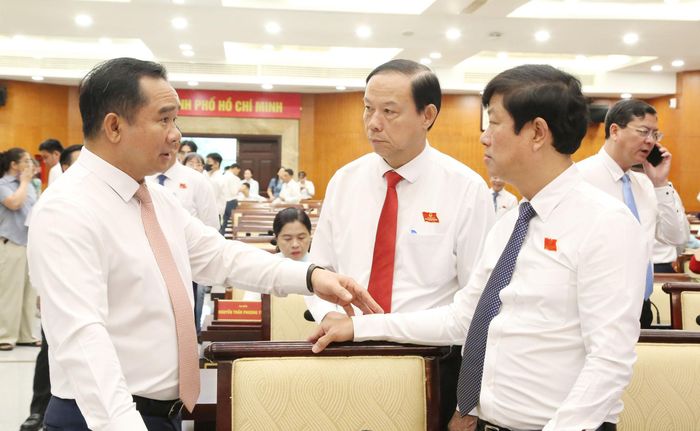Chủ tịch UBND Thành phố cùng Thường trực HĐND Thành phố trao đổi tại kỳ họp. Ảnh: Văn Dũng