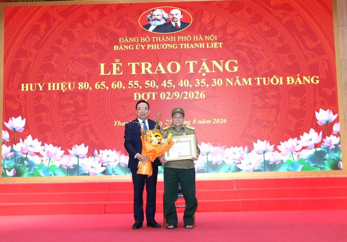 Đảng viên Nguyễn Anh Tuấn, Chi bộ Tổ dân phố số 2 Yên Xá, phường Thanh Liệt nhận Huy hiệu 80 năm tuổi Đảng. Ảnh: PV
