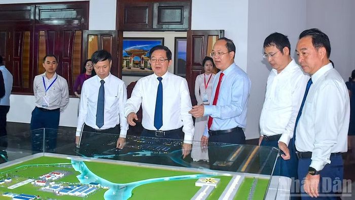 Phó Thủ tướng Chính phủ Hồ Quốc Dũng (thứ 4 từ phải qua) cùng các lãnh đạo tỉnh Cà Mau tham quan trưng bày không gian mới của Cà Mau sau hợp nhất tỉnh. (Ảnh: HỮU TÙNG)