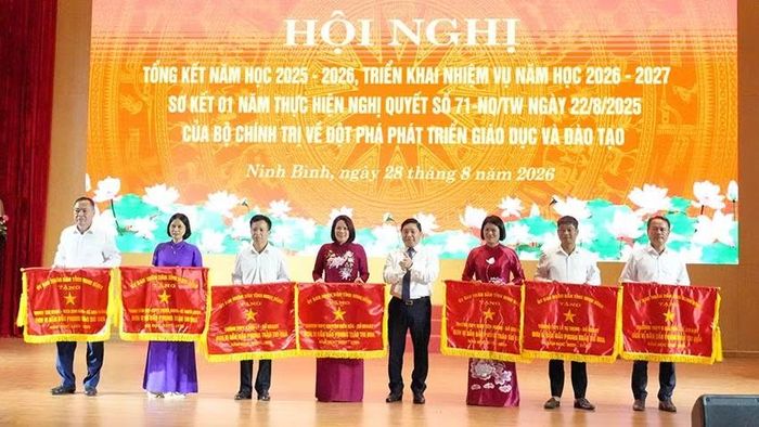 Thừa ủy quyền, đồng chí Nguyễn Tiến Dũng, Tỉnh ủy viên, Giám đốc Sở Giáo dục và Đào tạo trao Cờ thi đua xuất sắc của Ủy ban nhân dân tỉnh cho các tập thể. (Ảnh: HÀ NAM)