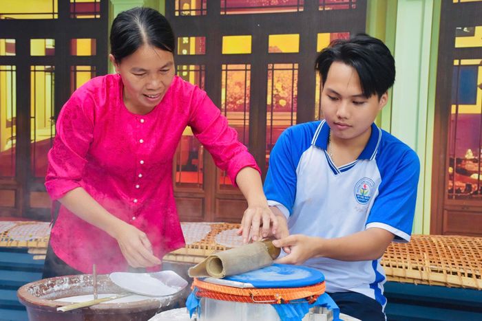  Nghệ nhân Trương Thị Mỹ Hạnh tận tình hướng dẫn các em học sinh trải nghiệm làm bánh tráng. 