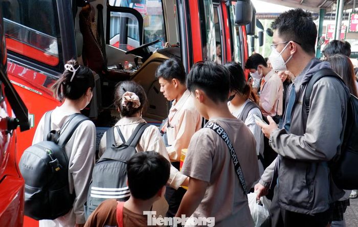 Trong dòng người chờ xe, nhiều hành khách tranh thủ kiểm tra lại hành lý, gọi điện thông báo với người thân trước khi lên xe. Một số gia đình có trẻ nhỏ chủ động đến bến sớm để tránh cảnh chen chúc vào giờ cao điểm.