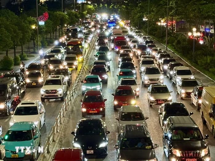 Các phương tiện vất vả rời Thủ đô trên đường Võ Chí Công. (Ảnh: Quốc Khánh/TTXVN)