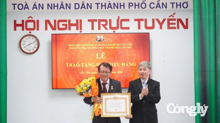 Bí thư Đảng ủy, Chánh án TAND TP Cần Thơ Thái Quang Hải trao tặng Huy hiệu 30 năm tuổi Đảng và tặng hoa chúc mừng đảng viên Trương Hoài Bình