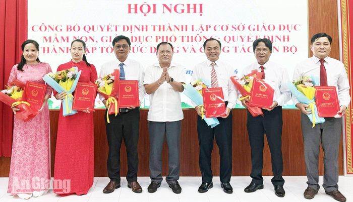 Phó Bí Thư Đảng ủy, Chủ tịch UBND phường Vĩnh Thông Ngô Việt Trung trao quyết định, tặng hoa chúc mừng cán bộ quản lý các trường sau sắp xếp.