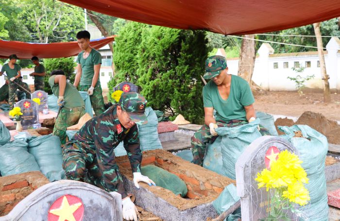 Trung tá Nguyễn Văn Ngọc, Phòng Chính trị, Bộ Chỉ huy Quân sự tỉnh cẩn trọng khai quật từng phần mộ liệt sĩ.