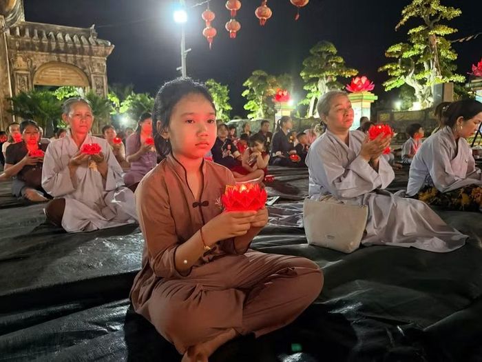  Từng ngọn nến được nâng niu thắp sáng cũng là một khoảng lặng để mỗi người con nghĩ về cha mẹ. Ảnh: Tổ Đình Thiên Đức 