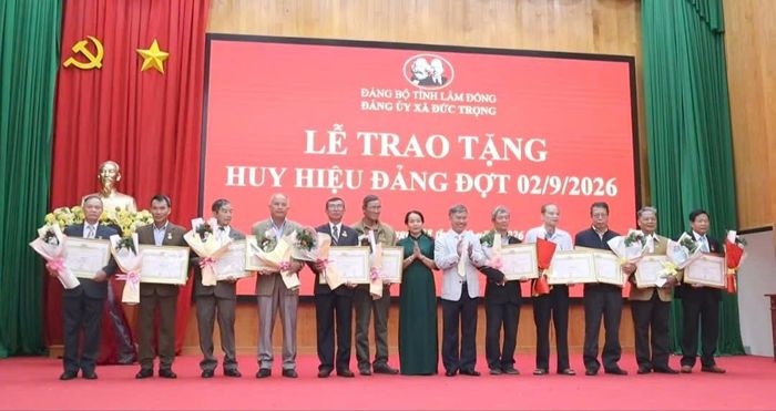 Đồng chí Phạm Thị Thanh Thúy, Phó Bí thư Thường trực Đảng ủy và đồng chí Lưu Trùng Dương, Phó Bí thư Đảng ủy, Chủ tịch UBND xã, trao Huy hiệu Đảng cho các đảng viên