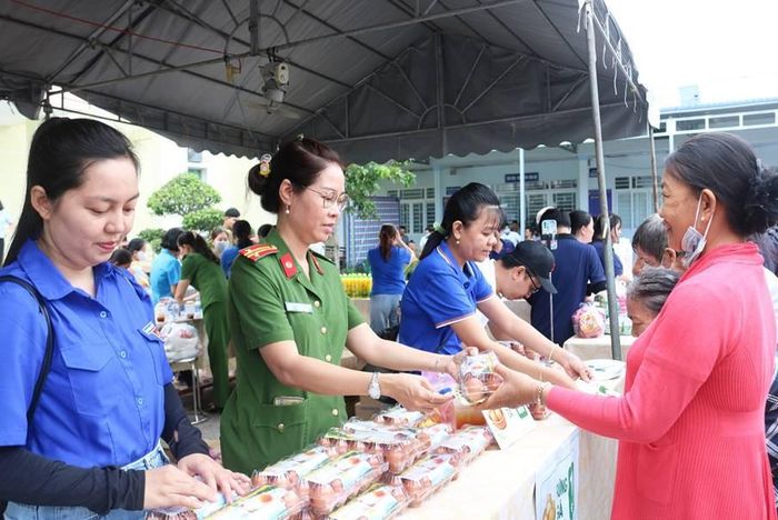 Cán bộ chiến sĩ Phòng Cảnh sát Thi hành án hình sự và Hỗ trợ tư pháp Công an tỉnh hỗ trợ người dân đến mua sắm tại các gian hàng với những vật phẩm trị giá 0 đồng. Ảnh: Nghiêm Túc