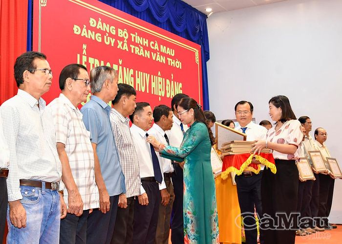 Phó Chủ tịch Thường trực HĐND tỉnh Lê Thị Nhung trao Huy hiệu Đảng và chúc mừng các đồng chí nguyên lãnh đạo huyện Trần Văn Thời (cũ) qua các thời kỳ.