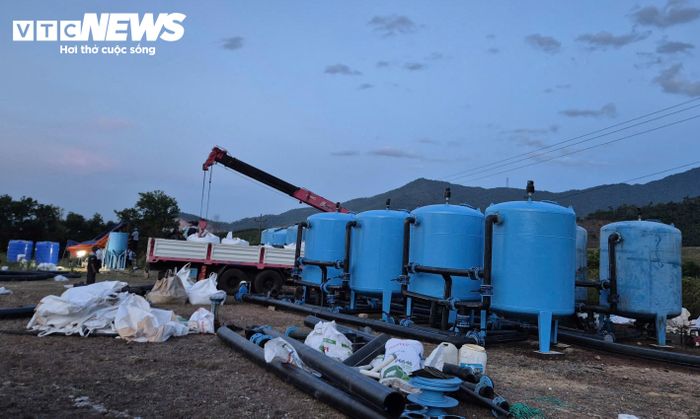 Dù trời đã tối, lực lượng chức năng vẫn làm việc để đảm bảo tiến độ lắp đặt hệ thống xử lý nước cơ động. (Ảnh: Đ.N.H)