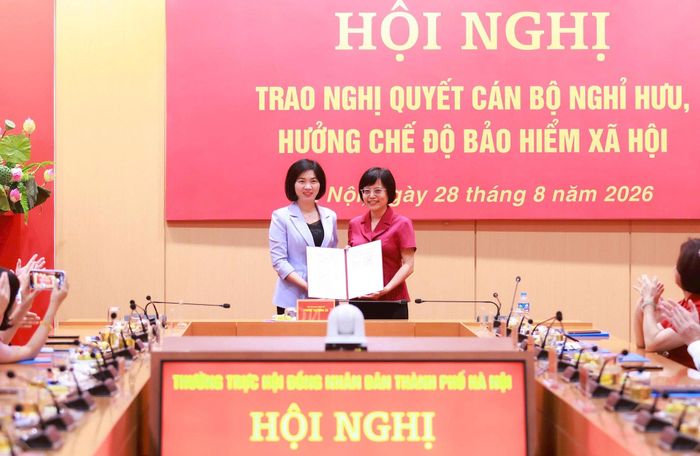 Phó Bí thư Thành ủy, Chủ tịch HĐND thành phố Phùng Thị Hồng Hà trao Nghị quyết nghỉ hưu đối với đồng chí Hồ Vân Nga. Ảnh: Văn Tuyến