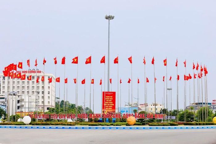 Những lá cờ Đảng, cờ Tổ quốc tung bay trong gió, tạo điểm nhấn tại khu vực vòng xuyến. Ảnh: Nguyễn Thanh Tùng