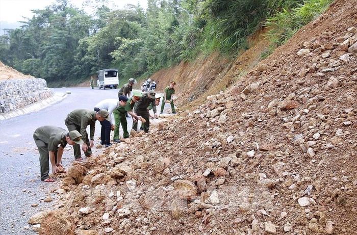 Lực lượng cán bộ xã, an ninh thường xuyên đi kiểm tra các điểm có nguy cơ tiếp tục sạt lở đường 448. Ảnh: Thanh Hải - TTXVN