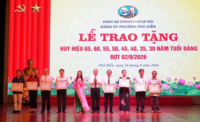 Bí thư Đảng ủy, Chủ tịch HĐND phường Nguyễn Lê Hoàng trao Huy hiệu Đảng tặng các đảng viên. Ảnh: Nguyễn Tâm