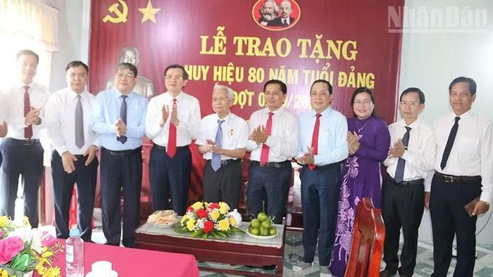 Đồng chí Đoàn Minh Huấn (thứ tư bên trái), Đoàn công tác Tỉnh ủy Vĩnh Long chụp ảnh lưu niệm cùng đồng chí Phạm Thành Nối. (Ảnh: MINH KHỞI)